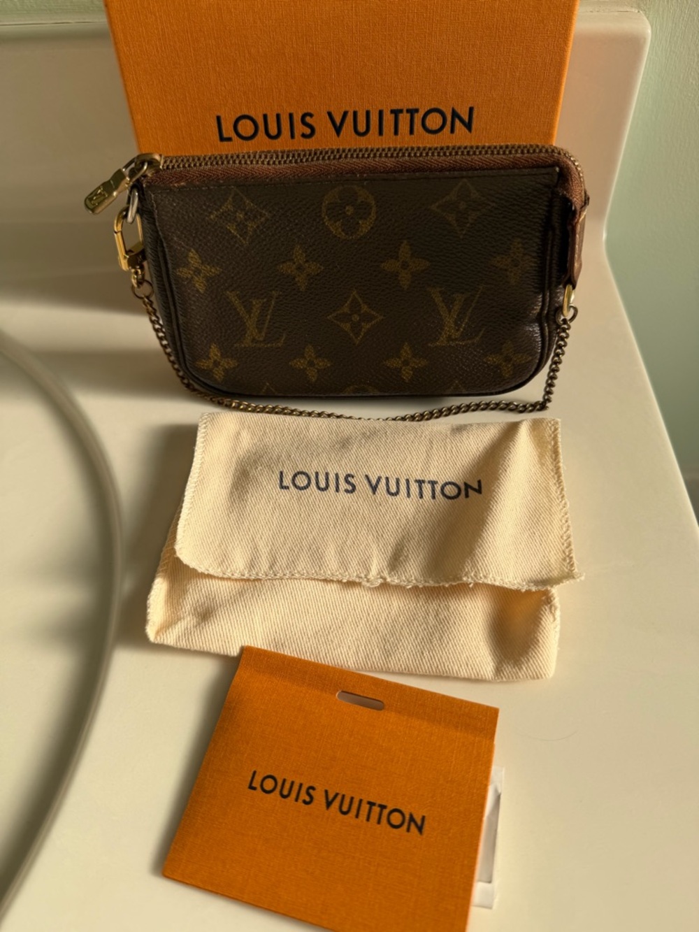 Louis Vuitton Monogram Mini Pochette in Brown with Gold Hardware